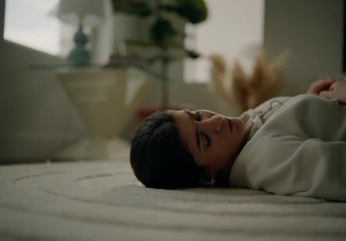 Woman sleeping on carpet in living room