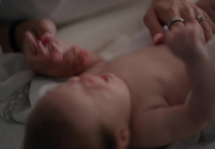 A mother is rubbing her baby