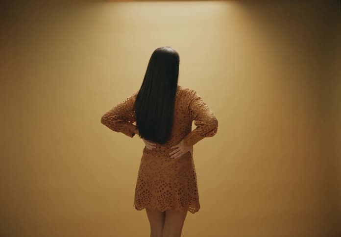 A pregnant woman is modeling a dress