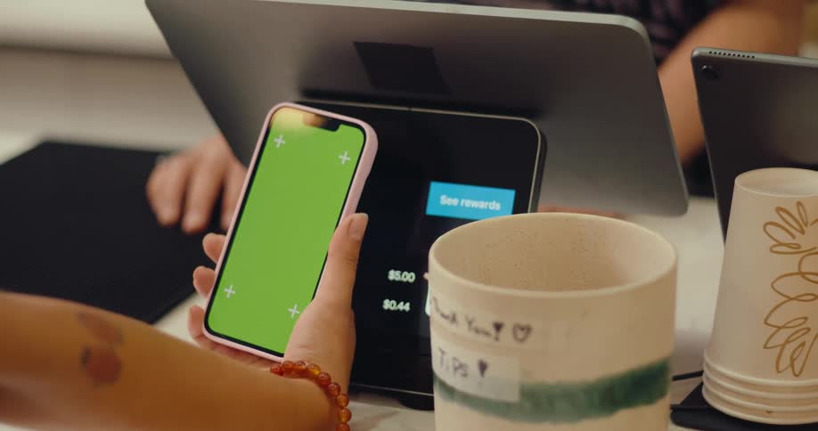 Hand holding a smartphone and making payment through digital wallet