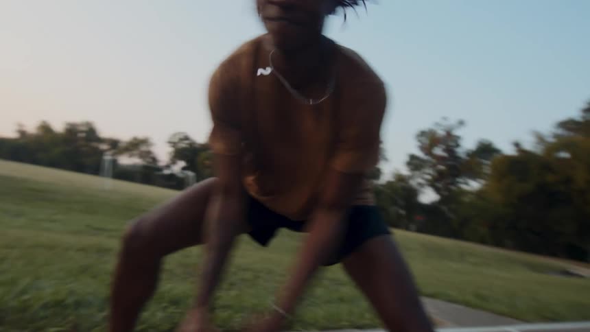 Boy on a basketball court dribbling and shooting at the basket