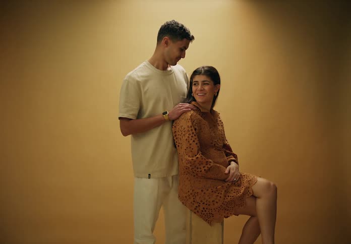 Couple posing and pregnant woman in a studio