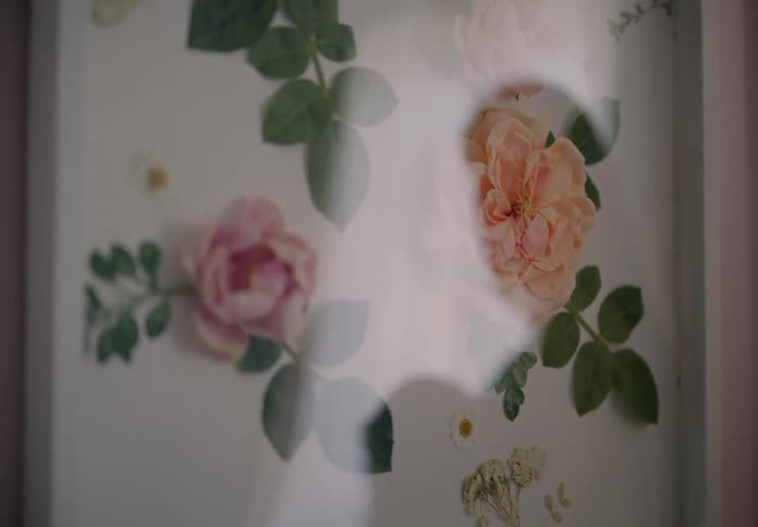 Reflection in a flower portrait of a mother holding a baby in her arms