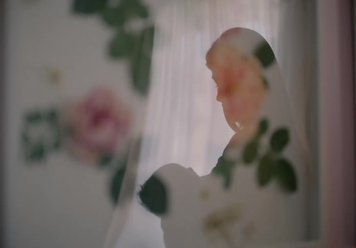 Reflection of a mother holding a baby in her arms