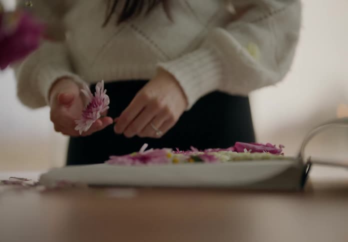 A woman is arranging flowers