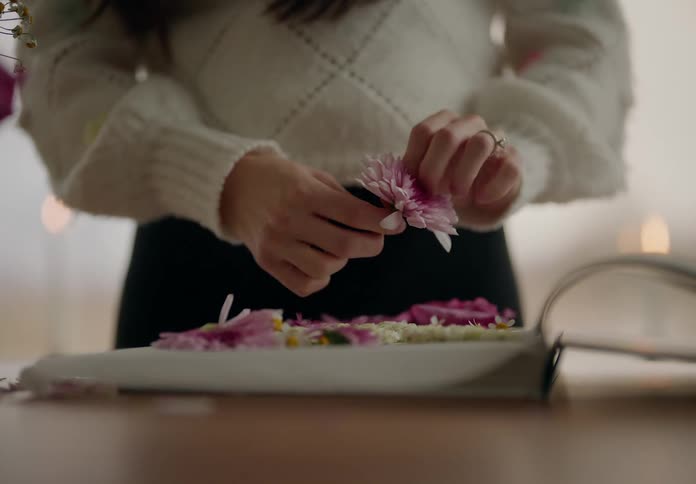 Hands of a woman making a flower composition