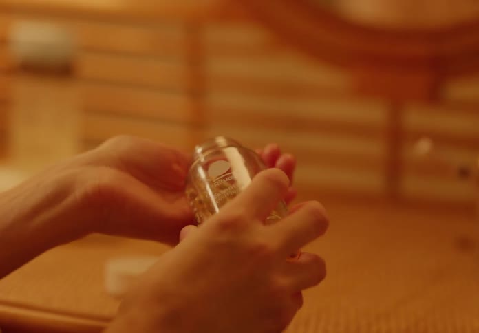 Person opens a pill bottle and dispenses one caplet