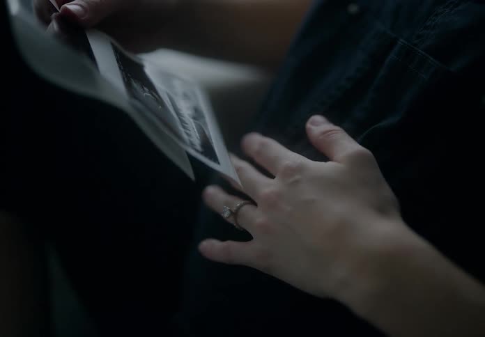 Closeup of a pregnant womans hand viewing an ultrasound image