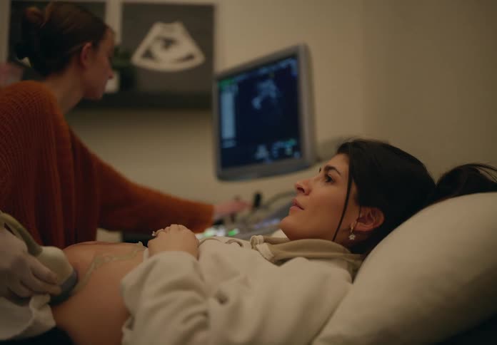 Pregnant woman lying down having ultrasound