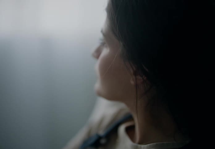 A womans face looking at something in front of her and then she looks to the right