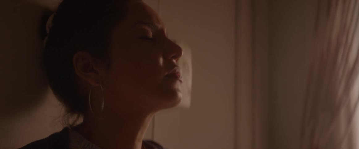 Woman resting her head back onto a door and closing her eyes