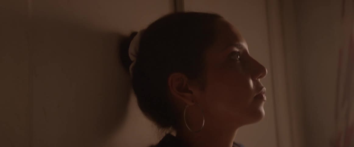 A woman leans against the wall