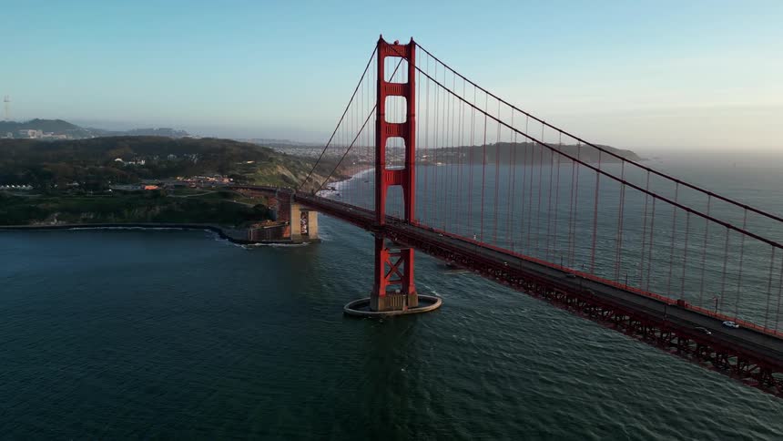 The golden gate bridge spanning over water showcasing its iconic red color and suspension design