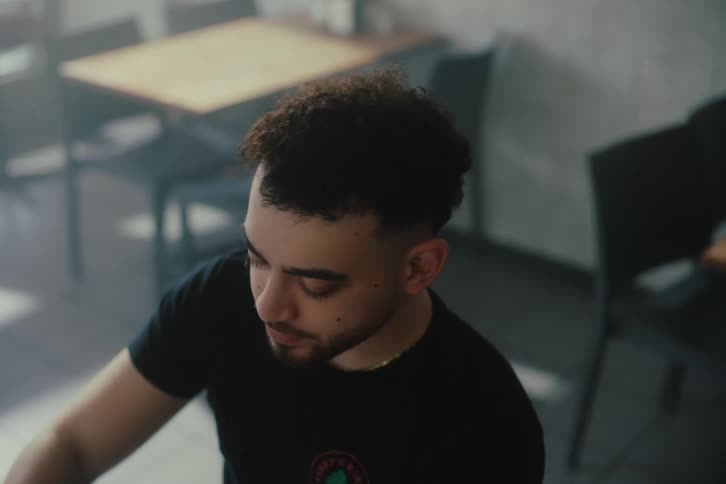 Man sitting in a coffee shop drinking a cup of coffee