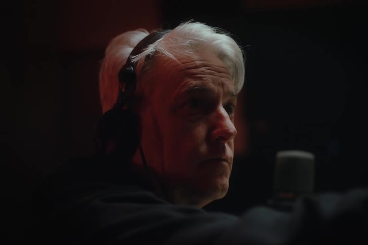 Portrait of a focused man with headphones in an indoor environment