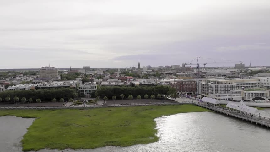 Aerial panorama of an urban city by a lake on a cloudy day