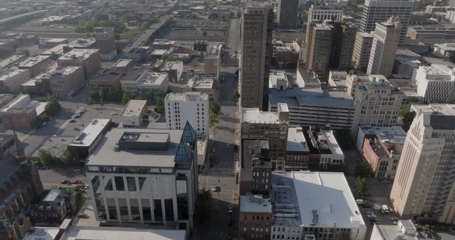 An aerial view of a cityscape following a main avenue at daytime