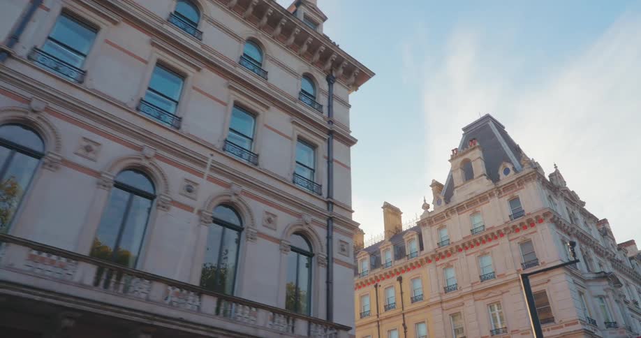 The grand facade of an ornate building stands against a clear blue sky