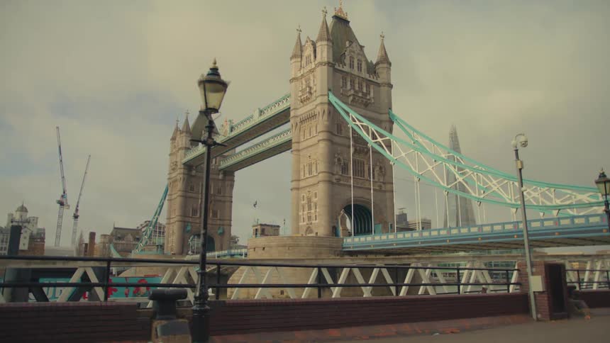 The tower bridge in london during the day under an overcast sky