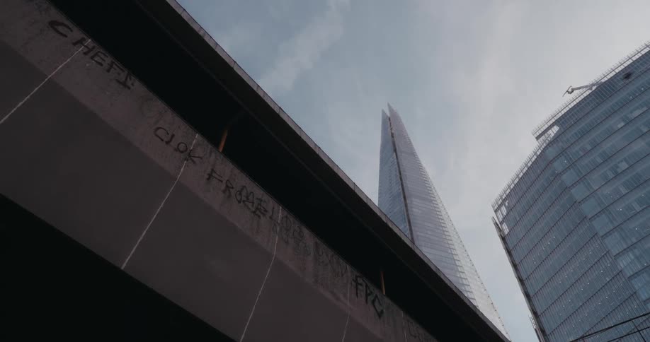 Upward view of large modern buildings against a cloudy sky