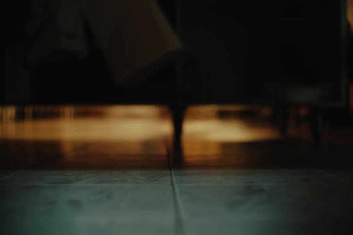 A person walks through a dark room
