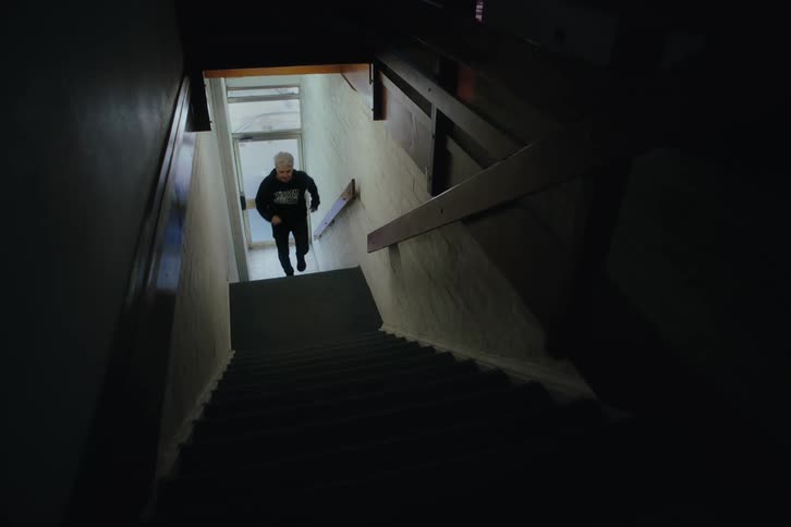Man climbing the stairs of a building