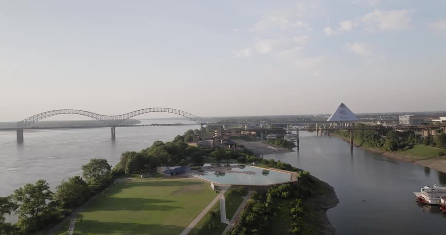 Aerial view of a city with a bridge over the sea in the background