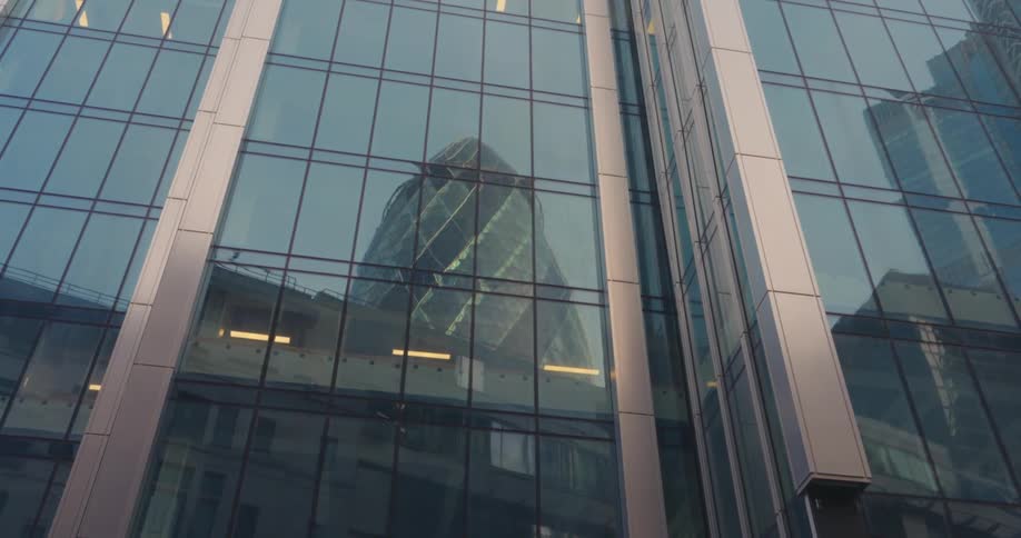 Mirrored modern building reflecting other buildings
