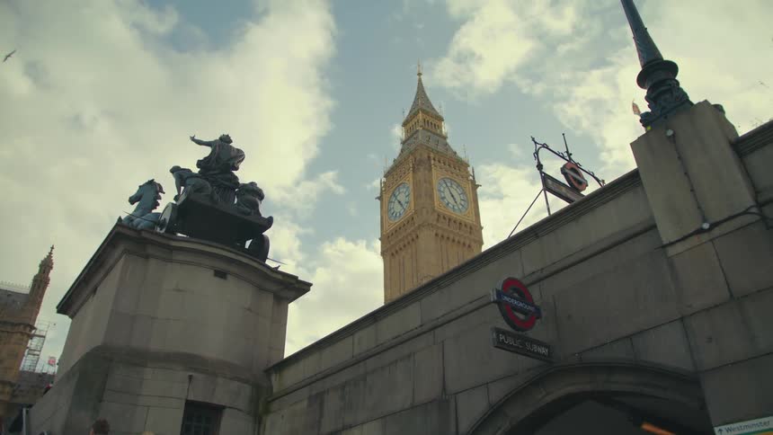 A clock tower is by the bridge