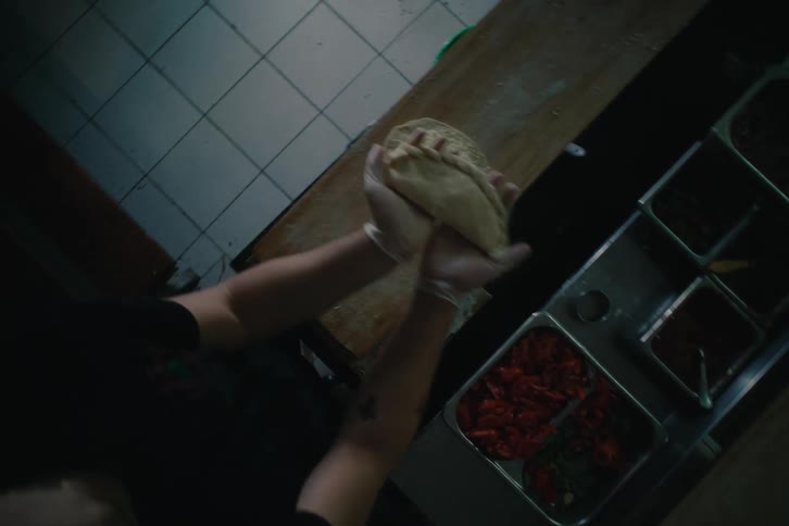 Top view of two people working on making dough for a roast