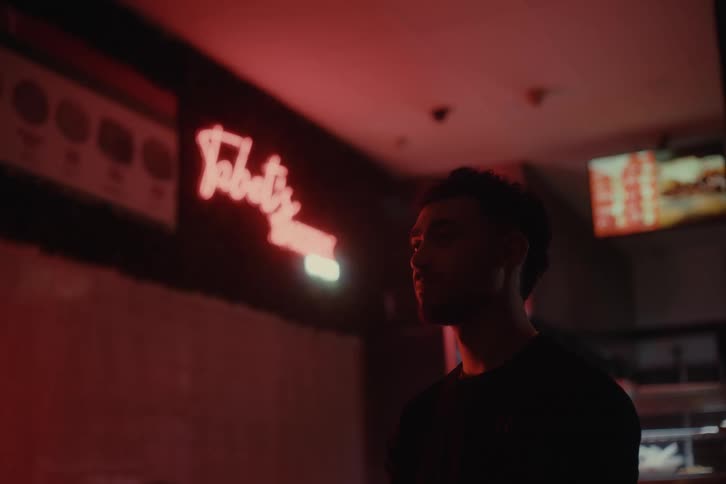 Silhouette of a man inside a restaurant with low lighting