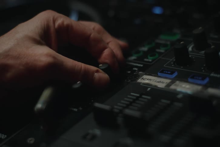 A person turns the knob on the control panel