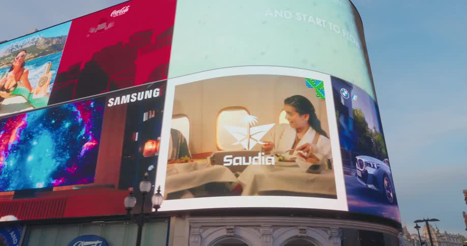 Screen showing commercials on buildings in a city
