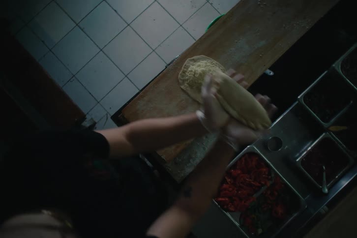 Topdown view of people preparing pastries on a restaurant