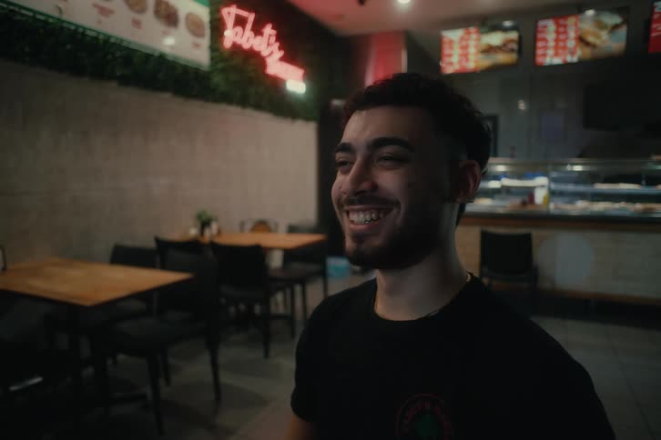 Portrait of a man laughing out loud inside a restaurant