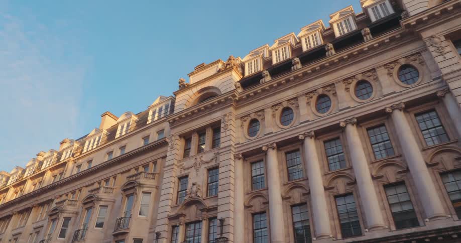 Grand ornate building with classical architectural features under a clear blue sky