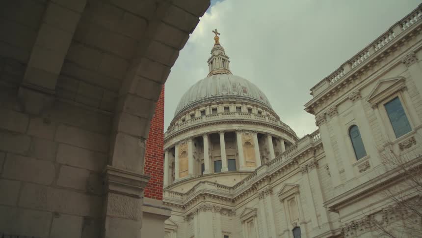 St pauls cathedral from a low angle point that includes surrounding buildings