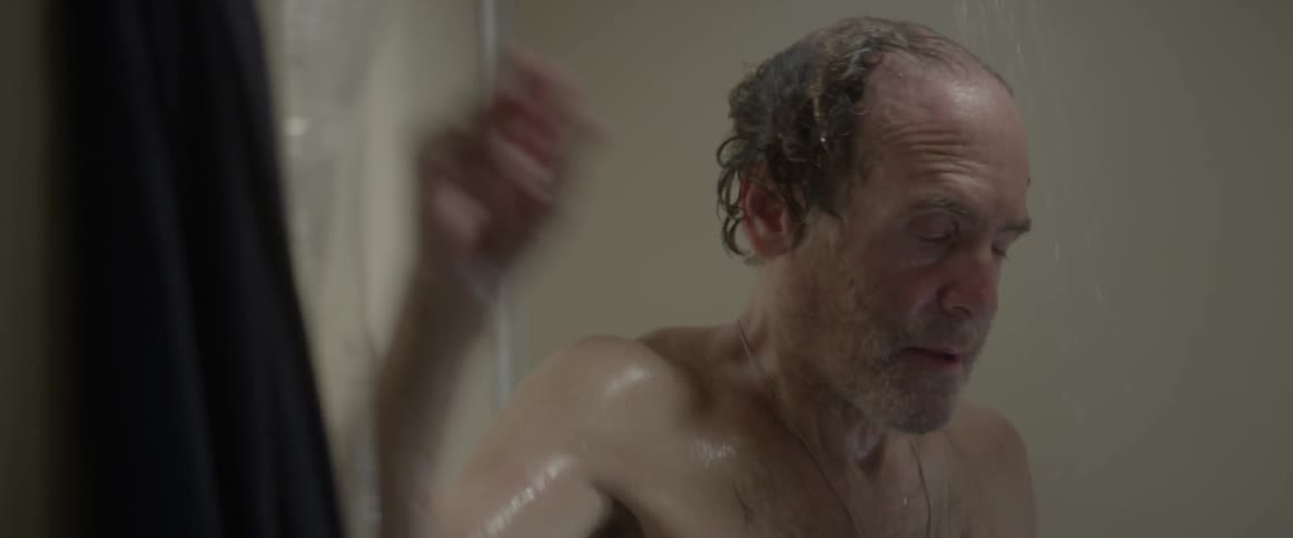 Man washing his hair in shower