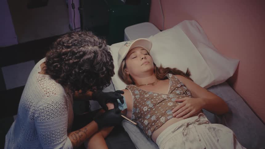 A woman is getting a tattoo