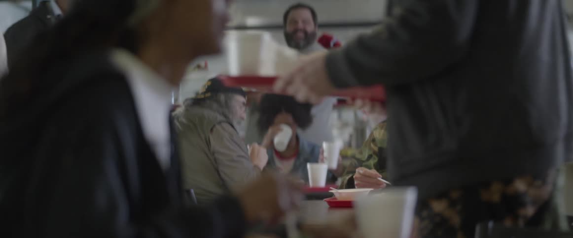 People sitting and eating food in a cafeteria