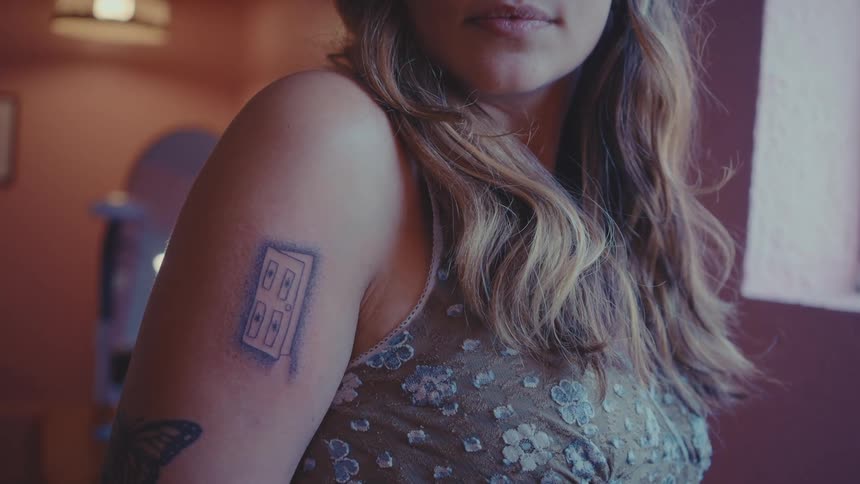 A closeup of a persons arm with a tattoo of a door