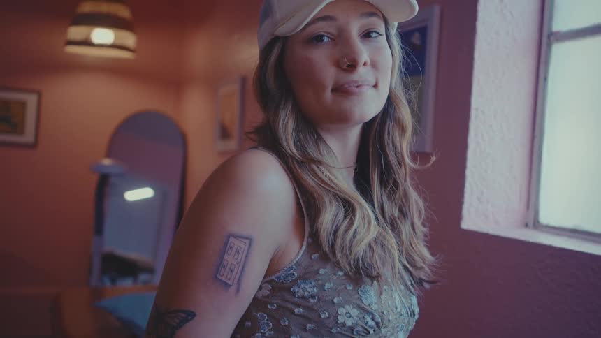 Portraits of a woman inside an establishment with a happy facial expression