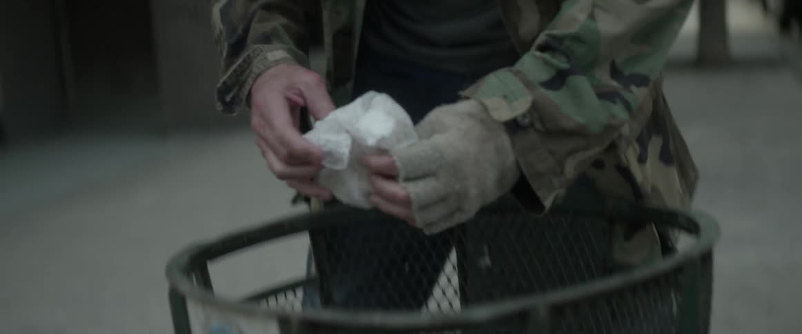 A man digs through the garbage removing some food