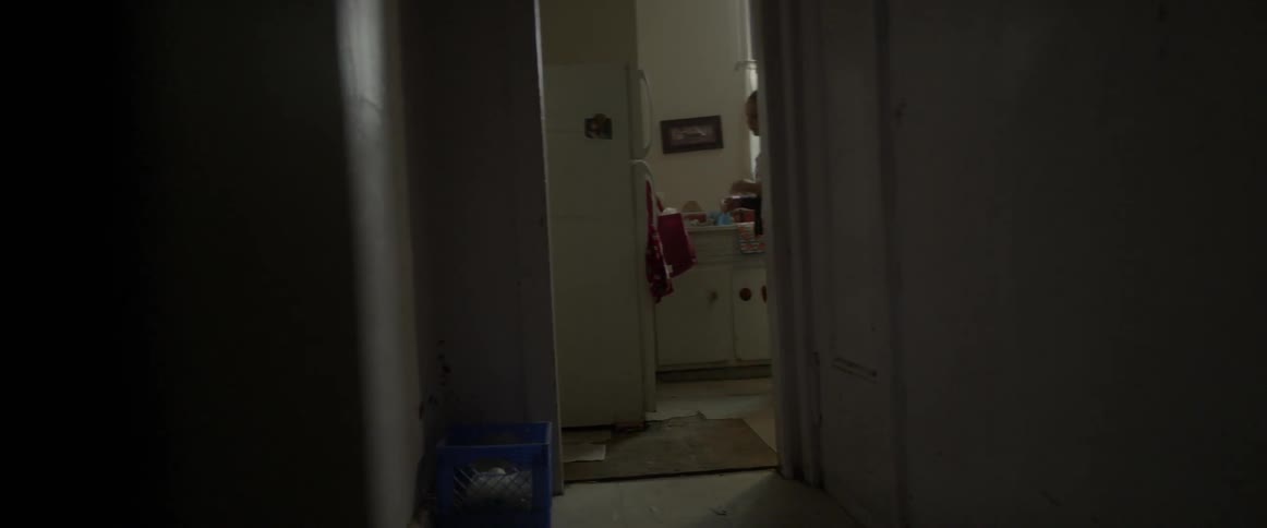 A woman is messing around in her kitchen and opening the refrigerator
