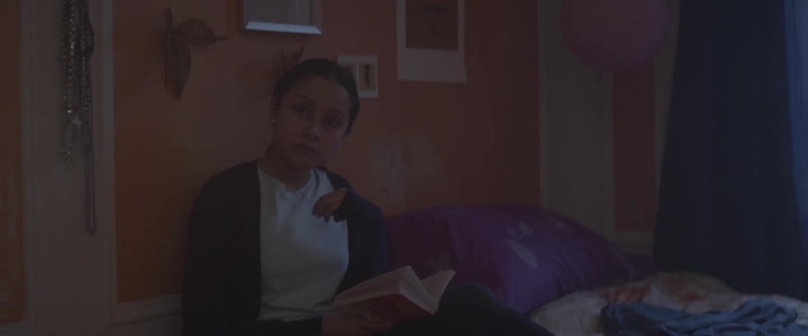 A woman sits in bed reading