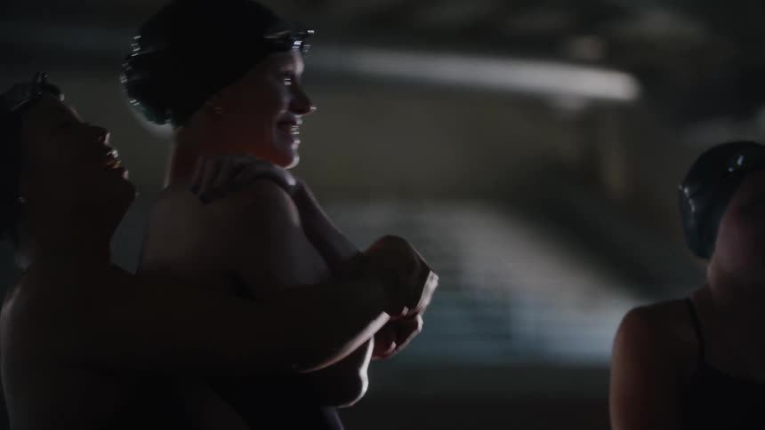Female swimmers talk and laugh