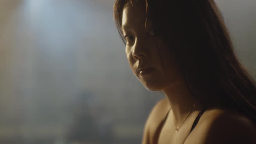 Portrait of a young woman looking to the side in a locker room