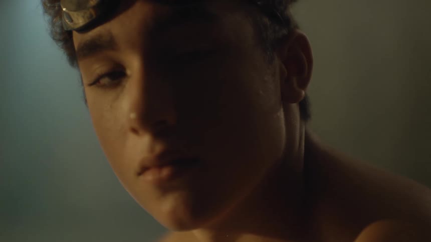 Portrait of a boy with a wet face and swimming goggles