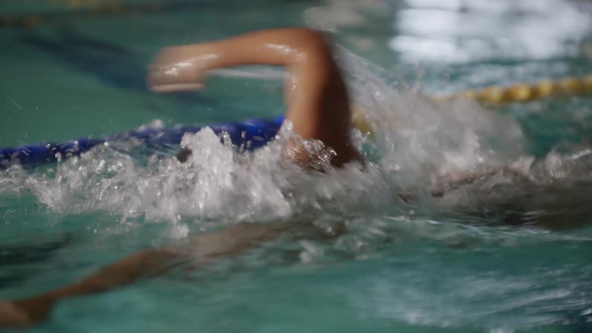 Swimmer swimming in the lane of a pool