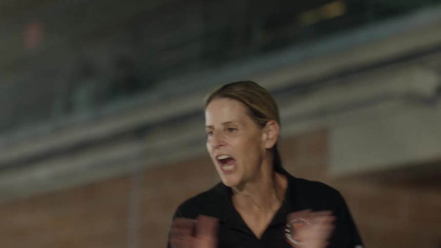 Woman walking while clapping and shouting in a motivational way
